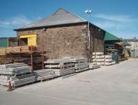 Almost fifty years after Morecambe Euston Road station closed, in 1962, the goods shed is still an integral part of the Travis Perkins builders' merchants site in the town centre. The loading bay awnings have been renovated and the whole building is in excellent condition. The passenger station itself succumbed soon after closure and residential flats cover that part of the site. Trains to Morecambe still run alongside the boundary fence of the old goods yard [See image 26601].<br><br>[Mark Bartlett 16/08/2010]