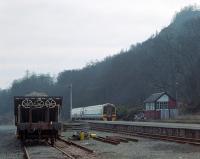 A Glasgow bound 158715 leaves Dunkeld station in 1991. Birnam Hill rises above the signalbox.<br><br>[Ewan Crawford //1991]