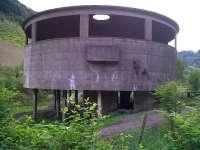 <I>It Came From Another Planet...</I> the sole remaining structure at the former Hafodyrynys colliery, which straddled the Pontypool-Neath line just East of Crumlin viaduct, is the former washery, seen here in May 2010. A local businessman asked for it to be left standing so that he could convert it into a restaurant. By the time he had found out that he couldn't get the curved glass needed for the windows, the demolition team had moved on.. the building still stands.<br><br>[Ken Strachan 31/05/2010]