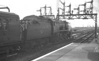 Bulleid <I>West Country</I> Pacific no 34009 <I>Lyme Regis</I> stands ready to leave Southampton Central in 1963 with the 9.30 am Waterloo - Bournemouth West. The cranes of Southampton Docks stand in the background.<br><br>[K A Gray 25/09/1963]