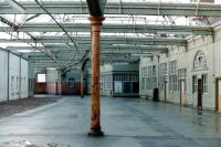 View over the fenced off <I>verboten</I> area at the north endof Gourock station in 1985 looking towardsthe old carriage entrance [see image 22615]. The roof glass has been removed and the infilled platform 1 is on the left (it was longer than the others). <br>
<br><br>[Colin Miller //1985]