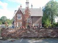 The station building at Appleby East, closed in 1962, still stands in excellent condition. The local school car park wall almost conceals the fact that, even though the line to Warcop hasn't been lifted, the whole of the station area is now occupied by a vehicle dismantlers with scrap cars covering the site. This view looks south towards Warcop. [See image 18204] showing the same location in 1983. <br><br>[Mark Bartlett 14/08/2010]