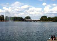 A Berlin bound ICE stops briefly on the bridge sandwiched between Kennedybruke to the rear, and Lombardsbruke, on the outskirts of Hamburg, on the afternoon of 27th July 2010, as a couple sit and relax alongside the Binnenalster.<br><br>[John Steven 27/07/2010]