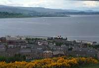 TSMV Pioneer leaves Gourock Pier in 1991. The view is from Tower Hill. At this time The Bay Hotel still stood next to the station and can be seen to the left of the glazed canopies. The CalMac building is to the right of the station. In the distant right is Helensburgh and to the left Rosneath.<br><br>[Ewan Crawford //1991]