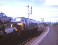 A car train photographed at the west end of Bathgate station, thought to have been taken in 1969. The train is probably the 4S42 ex-Dagenham, on this occasion conveying Mk 2 Ford Cortinas, the favoured choice of many a notable railway photographer of the period [see image 29963]. <br><br>[Jim Peebles //1969]
