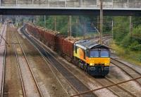 Colas Rail 66841 heads south on the WCML Up Fast line at Farington <br>
Junction on 25 August 2010 with the Carlisle - Chirk log train. In the distance on the left is another Class 66 heading south on the Up Slow. To the right of the log train are the tracks from Lostock Hall Junction and the East Lancashire lines.<br>
<br><br>[John McIntyre 25/08/2010]