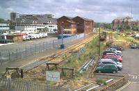 It's easy to dwell on the losses at Bedford - not least the direct trains to Cambridge and Northampton. But this view is full of history. Notice the MR warehouse dead centre - the sidings in front of it used to be the Hitchin line - a main line to London, no less. In the distance above the wagons, we can see where this line has been 'recycled' as the link between Bedford's two stations - Midland and the 'new' St John's. On the right, the catenary supports are over the carriage sidings for the <i>Bed-Pan</i> EMUs. [See image 21393]<br><br>[Ken Strachan 16/07/2010]