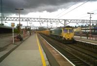 Freightliner 66609 rumbles south through Stafford with Network Rail hoppers on 5 August. This would have been a less interesting picture, but for the angry-looking black cloud that came along at just the right time. The blue building just visible on the extreme right used to be the nearest pub to the station - its affiliation to the Titanic brewery was perhaps prophetic.<br><br>[Ken Strachan 05/08/2010]