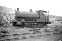 Peckett 0-4-ST no 1152 stands alongside Swansea East Dock shed on 28 June 1959. The locomotive had been built in 1907 (originally number 12) for the Swansea firm of Powlesland and Mason who supplied locomotives and crews for use in Swansea Docks until eventually being merged with the GWR in 1924. No 1152 was the last of the former P&M locomotives in service with BR, being eventually withdrawn in 1963.<br>
<br><br>[Robin Barbour Collection (Courtesy Bruce McCartney) 28/06/1959]