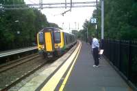 No shortage of cant at Long Buckby as the 15.06 to Birmingham New Street stops at this country station to the north of Northampton in July 2010. The tarred felt platform surface is a lot less slippery when wet than the original planks!<br><br>[Ken Strachan 30/07/2010]