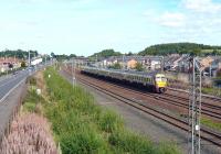 The 15.00 service from Glasgow Central to Ayr westbound at Arkleston Junction on 31 August, passing the greenery on the left that marks the path of the old Renfrew Line. Track workers are at the ends of the goods loops perhaps preparing for the third track. The loops looked decidedly rusty today.<br><br>[Colin Miller 31/08/2010]