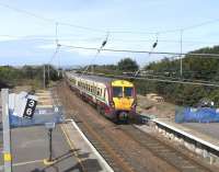 The coming of 4-car class 380s in December will mean that platforms <br>
along their routes, in Inverclyde and Ayrshire, will have to be able to accommodate 8-car trains rather than the current 6.  Many if not most are therefore being extended.  Here at Troon on 1 September a 6-car Juniper approaches bound for Ayr, passing the extension works.  That hardware on the northbound platform (the smaller one is an 'OFF' indicator) will have to be moved along a bit.<br><br>[David Panton 01/09/2010]