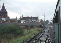 The Railway Society of Scotland charter DMU passing through Coupar Angus. The whitewashed building in the background is the Strathmore Hotel (known as 'The Whitehouse' to local railwaymen who allegedly visited it from time to time) with the Tolbooth steeple on the left of the picture. The trackbed now forms part of the Coupar Angus bypass and the bracketed signal gantry in the right background now controls access to the SRPS station at Boness. Photographed in October 1968 a year after official closure to passengers, which occurred on 4 September 1967. <br><br>[Bruce McCartney 12/10/1968]