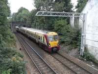 334 002 approaches journey's end at Gourock on 1 September, heading, <br>
so the indicator on the signal behind me says, for platform 1. The <br>
leafiness belies the fact that the sea is only 100 yards away.<br>
<br>
<br><br>[David Panton 01/09/2010]