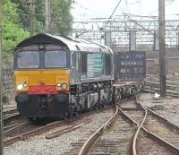 DRS 66413 takes the Platform 4 road through Preston as it heads north with a container train. The lines in the foreground are for bay platforms 3C and 4c [See image 30103]. In the <I>old days</I> a northbound train like this would have been signalled through the down side platforms but all lines in Preston station are now bi-directional. <br><br>[Mark Bartlett 04/08/2010]