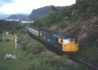 An eastbound Inverness-Kyle of Lochalsh trains slows for Plockton in the summer of 1983, with Loch Carron in the background.<br><br>[Frank Spaven Collection (Courtesy David Spaven) //1983]