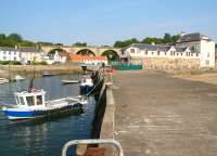 The harbour at Lower Largo, Fife, looking back towards the village, with the remains of the viaduct that once carried the Fife Coast line dominating the background. Lower Largo was, as every schoolboy knows, the home of Alexander Selkirk (1676-1721) a local sailor who spent 4 years marooned on a desert island and who is believed to have been the inspiration for Daniel Defoe's novel <I>Robinson Crusoe</I>. Not that you'd know it here! Morning coffee is being taken in <I>The Castaway Bar</I> in the background, with the <I>Crusoe Hotel</I> standing on the right. The signpost at the roadside includes a pointer to <I>Juan Fernandez Island (7,500 miles)</I>. For some reason the expression <I>Thank God it's Friday</I> came to mind... <br>
<br><br>[John Furnevel 03/09/2010]