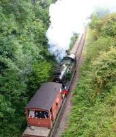 Ex-GWR O-6-2T no 5637 (in its final lined out BR passenger green) banking a freight train up the 1:56 towards Merryfield Halt on the East Somerset Railway on 4 September 2010.<br><br>[Peter Todd 04/09/2010]