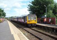 Four coaches, unusual for the Heysham Port to Leeds train, means a long trudge for the signalman back to the Bare Lane box with the single line staff and the point lock keys for the Heysham branch. 144007 and 142087 are the Northern Pacer units on this occasion.<br><br>[Mark Bartlett 26/08/2010]