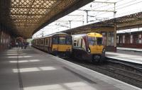 A class 318 bound for Largs passes an incoming 334 at the Ayrshire <br>
platforms at Paisley Gilmour Street on 1 September. I'm not sure to <br>
what extent the forthcoming 380s will take over Ayrshire and Inverclyde services when they are introduced in December, but I can't imagine this sort of scene - or one including a 314 - will be too common. <br>
<br><br>[David Panton 01/09/2010]