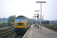 As a Norwich-London service enters Ipswich on 24th September 1977, a trainee driver sets out to spoil the photograph and convey his attitude to rail enthusiasts by gurning and gesticulating. This kind of mockery was new at the time, but it spread widely towards the end of the last century, fostered by some comedians who chose to target 'anoraks' as an alternative to more politically assertive groups. If the trainee is a driver today, he will now be in his 50s. Here's hoping nostalgia for the 1970s railway scene brings him to this photo! <br><br>[Mark Dufton 24/09/1977]