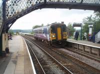 Arnside sees 153359 call on a Cumbrian Coast service heading for Lancaster. In the background the signal box can be seen overlooking the Kent Estuary at high tide. I travelled on this service from Ulverston and it is amazing just how many people can be crammed into a <I>bubble car</I> but Northern really ought to consider using two car units on Saturdays!<br><br>[Mark Bartlett 11/09/2010]