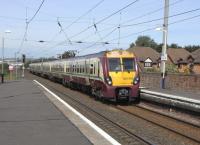 A fine late summer day, and the canvassy smell of warm Ayrshire golf <br>
links wafts across Prestwick Town station. The Ayr-bound 6-car 334 has had little chance to build up any speed from its previous stop at Prestwick International Airport station less than half a mile away.Town station is one of the few with platforms long enough to safely accommodate the forthcoming 8-car 380s, so no lengthening work in eviidence here.<br><br>[David Panton 01/09/2010]