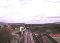 View south east from Burscough Bridge towards Wigan in May 1986. The trackbed of the former spur to Burscough North Junction (closed 1969) runs off to the left of the signal box, while   the line to Burscough South Junction, closed 3 years previously, is still in place. The DMU is about to run under the bridge carrying the Preston - Liverpool line. [See image 22975]<br>
<br><br>[Ian Dinmore /05/1986]