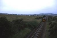 A southbound 158 slows on the northern approach to Dyce station one evening in 1995, passing the site of what is now Raiths Farm freight depot(opened in 2008) [see image 17345] . [With thanks to all respondents]<br><br>[David Spaven //1995]