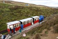 Glengonnar station on the Leadhills and Wanlockhead branch is <br>
viewed from above the cutting with the last train of the day about to depart for Leadhills on 12 September 2010. Glengonnar is the summit of the former standard guage line from Elvanfoot to Wanlockhead and was the highest point worked by adhesion on the UK railway network at 1498 ft above sea level.<br>
<br><br>[John McIntyre 12/09/2010]