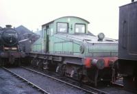 A long way from the quayside! ES1 electric locomotive 26501 stands on Kingmoor shed minus collector shoes and pantograph (not that they'd have been much use here). Both class ES1 locomotives (the other being 26500) were withdrawn from Newcastle's quayside branch in early 1964 following which they were taken to Hellifield, where the old shed was used by the NRM to assess, store and refurbish potential preservation material. The photograph is thought to show 26501 on its way back to the north east from Hellifield in 1966. Following some talk of private preservation, 26501 appears to have been abandoned in a siding near the former station at Choppington, Northumberland, where she was eventually cut up in August 1966. On a happier note, no 26500 was later restored and refurbished and is currently a star exhibit at the NRM centre at Shildon. [see image 17307].        <br>
<br><br>[Robin Barbour Collection (Courtesy Bruce McCartney) //1966]