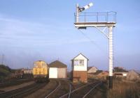 Until the 1982 displacement of Class 26s by Class 37s (the Class 24s having left Inverness in 1975), the only other locos seen regularly north of Muir of Ord were the 1,000 horse power Class 20s, hauling oil trains from Bowling (on the Clyde) to Invergordon Distillery. Here, one of the class accelerates a southbound empty tank train out of Invergordon loop in the summer of 1973.<br><br>[David Spaven //1973]