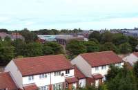 View north at Tynemouth in August 2010 with the station in the middle distance and the neglected ironwork over the south bays obvious. The trackbed of the long bypassed Newcastle and North Shields route in the foreground is now a street of houses with Tynemouth Road running beyond. [See image 21848 to compare the scene in the eighties.] <br><br>[Colin Alexander 18/08/2010]