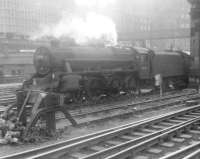 Black 5 at Waverley. 45359 sneaks along the outside of the south wall with an unidentified train in 1965. Of note in the background is the pedestrian metal bridge that spanned the station between Jeffrey Street (the junction with which can be seen through the steam) and Calton Road.<br><br>[Jim Peebles //1965]