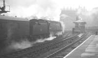 <I>Invasion of the Spam-cans II</I> - Nottingham, March 1963. Another of the football specials carrying Southampton fans arrives through the mist and rain at Nottingham Victoria on 30 March 1963, this one hauled by <I>Battle of Britain</I> Pacific no 34054 <I>Lord Beaverbrook</I>. No doubt the floodlights were in use throughout the match at The City Ground that particular Saturday afternoon. [See image 30756] <br><br>[K A Gray 30/03/1963]