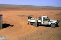 A view from a train Murina 'station' in the Nullarbor on 25 September 2008. A passenger disembarks, puts his 'swag' (a suitcase and a laptop) into the back of the vehicle, then speeds off in a cloud of dust. Not an intensive service here - two trains each way per week. <br>
<br><br>[Colin Miller 25/09/2008]