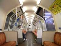 Interior shot of a Glasgow Subway car, taken on 11 September. You don't have to be freakishly tall to find that you can only stand up straight in the central section. It has to be said that the subway map is not quite as interesting as even the LU Circle Line diagram.  Even then it cheats a bit by showing the Inner and Outer Circles separately which, when you think about it, can't possibly be of help as there's only an even chance that the arrows show the correct direction of travel as you face the diagram. Don't give yourself a sore head thinking about this. <br>
<br><br>[David Panton 11/09/2010]