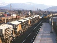 Two Class 26s pull into Aviemore in 1974 with a northbound passenger service, while sister locomotive no D5321 waits for the road to Kingussie with a Millerhill-bound freight dominated by empty Preslo cement wagons for Blue Circle at Oxwellmains.<br><br>[Frank Spaven Collection (Courtesy David Spaven) //1974]