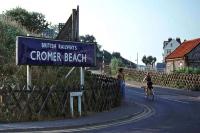 Twenty-two years after the 1954 closure of Cromer High station, the remaining Midland and Great Northern station in the town was still signed 'Cromer Beach' to distinguish it from the former Great Eastern terminus. The present day station is now just plain 'Cromer', and the replacement signage on this street corner reads 'Welcome to Morrisons'. <br><br>[Mark Dufton 14/08/1976]