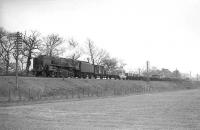 A BR Standard class 9F 2-10-0 with a down WCML Freight passing Wamphray, thought to be in April 1965.<br><br>[Robin Barbour Collection (Courtesy Bruce McCartney)  /04/1965]