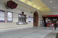 I must say that the ticket hall at Greenock West looks a great deal  more inviting than it did when I first visited some years ago, though  that wouldn't be difficult.  The transition to the red sandstone of the  rest of the station is tastefully done.  The security camera appears to  be trained on the cafe's sole, bunnetted customer but I'm sure it isn't  really...  <br><br>[David Panton 01/09/2010]