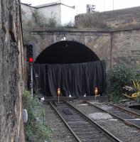 Haymarket North tunnel, mostly used by services on the Forth Bridge line, is currently closed at weekends to allow installation of overhead wires which the South tunnel has had for nearly 20 years.  On Saturdays at least this means local services from Fife are terminating at Haymarket and there are some alterations to other services.  This view is taken from Platform 1 at Haymarket looking towards Waverley.  Not sure what the curtain is for; do the workers put on a show at the end of the day? <br><br>[David Panton 02/10/2010]