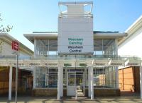 Minimalist entrance to the new Wrexham Central station in April 2010, with bi-lingual station name and main destinations for services from the station<br><br>[David Pesterfield 22/04/2010]