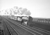 St Margaret's 'shovel-rim' V2 no 60813 at Drem with what is possibly the 3.30pm (SX) Edinburgh Waverley - Berwick stopping train (believed to have originated as the 2.42 pm from Corstorphine) in the early 1960s (these locals ceased in May 1964).<br><br>[Robin Barbour Collection (Courtesy Bruce McCartney) //]