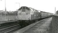 27040 brings a westbound train through Dundee Esplanade circa 1985. Closed to passengers in 1939 the station was later adapted for use in its current role as the works and maintenance centre for the Tay Bridge.<br><br>[Ken Browne //1985]