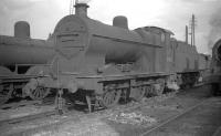 Fowler 4F 0-6-0 no 44011 stands on Ladyburn shed, Greenock, in the summer of 1960. <br><br>[Robin Barbour Collection (Courtesy Bruce McCartney) 31/08/1960]