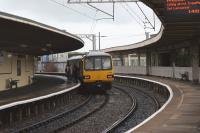 The early afternon DMU service from Morecambe to Leeds in the hands of 144005 calls at a wet Carnforth station on 1 October 2010.<br>
<br><br>[John McIntyre 01/10/2010]