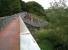 A replacement bridge over the Avon East of Chippenham on the Calne branch, which has recently been converted into a quality foot/cyclepath with a rolled stone surface, seen here in August 2010. Unusual features include the kink in the middle (no insult intended to the gent in shorts) and the lower level viewing platform on the right.<br><br>[Ken Strachan 30/08/2010]