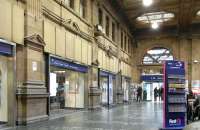 The North British Railway wasn't allowed to build any part of its <br>
principal station above the level of Princes Street, so it has no <br>
facade, imposing or otherwise - though they did make up for this in <br>
their hotel which is anything but discreet. The station's booking hall is however rather grand and has an ornate ceiling. Unfortunately the hall is dominated by a chain coffee outlet in the centre which gets in the way of a decent picture so this view of 29 September is of the southern side only.<br><br>[David Panton 29/09/2010]