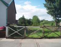 Just to the north of Appleby East, on the now disused line to Penrith, is this level crossing beyond which the rails continue to a headshunt with a trailing link to Appleby (West). The line closed to passengers in 1962 but this section remained open for freight to Warcop until 1989. [See image 21207] for the <I>view</I> in the opposite direction from the same point.  <br><br>[Mark Bartlett 14/08/2010]